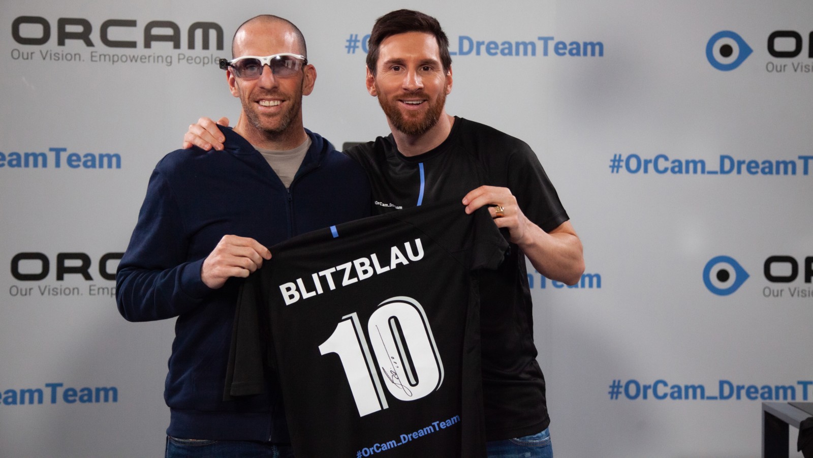 Triathlete, who lost vision in terror attack, wears OrCam while posing with Messi