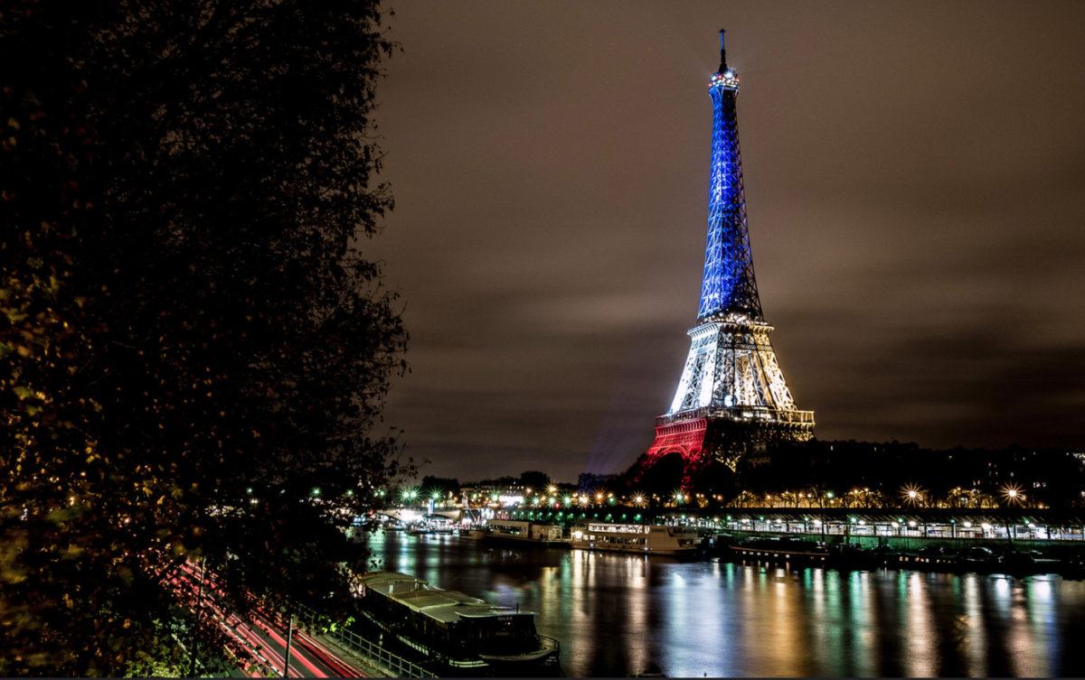 The Eiffel Tower illuminated in blue, white and red.