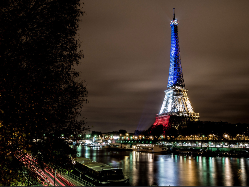 The Eiffel Tower illuminated in blue, white and red.
