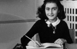 Anne Frank, age twelve, at her school desk. Amsterdam, the Netherlands, 1941. (Anne Frank Stichting)