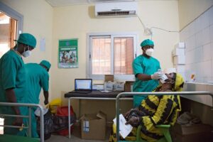 A healthcare worker performs a nasal swab as he tests a woman for COVID-19 in Bamako, Mali.