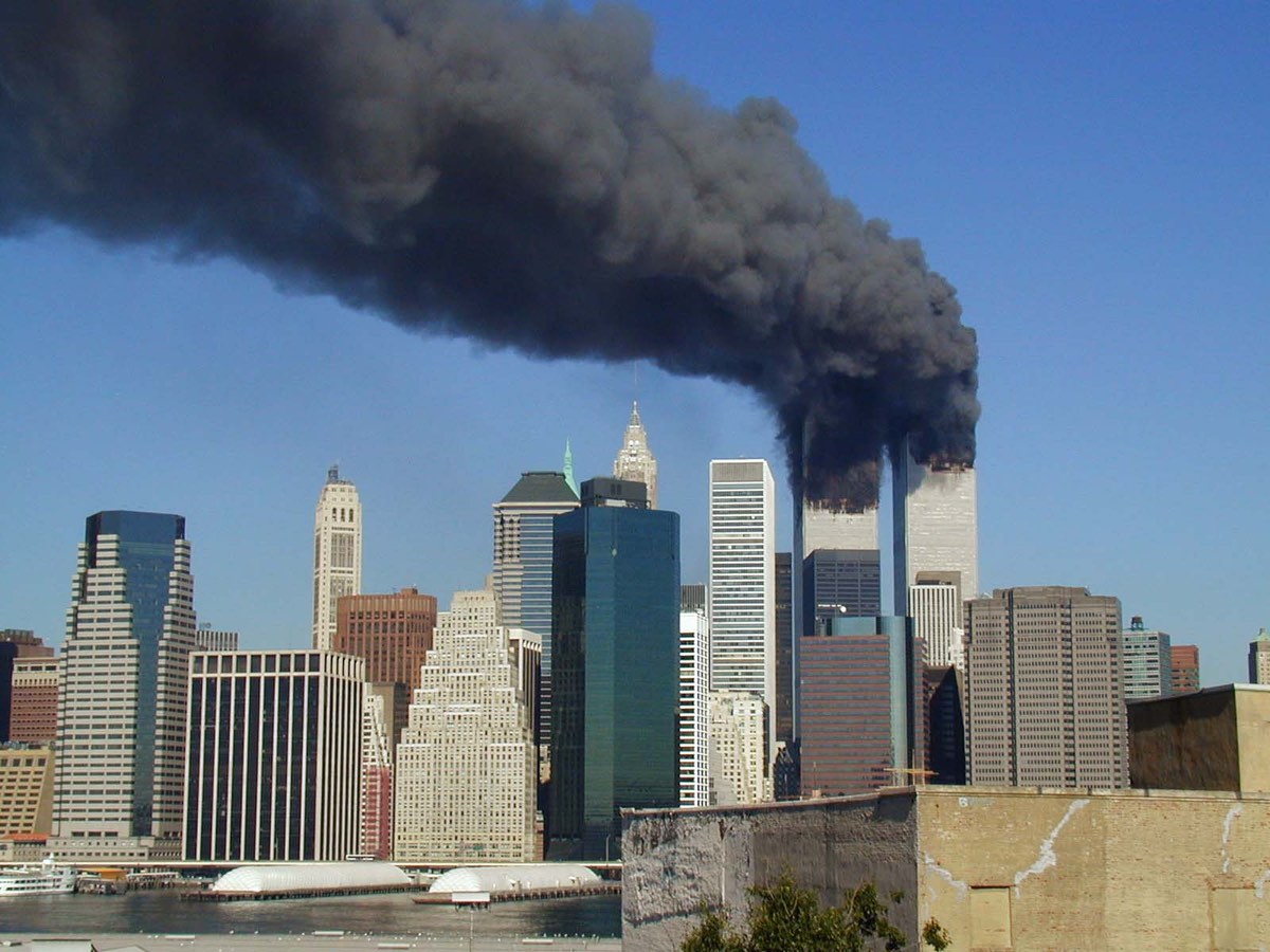 A view of the twin towers of the World Trade Center in New York City on fire after hijacked planes flew into the buildings on the morning of Sept. 11, 2001; Commons.