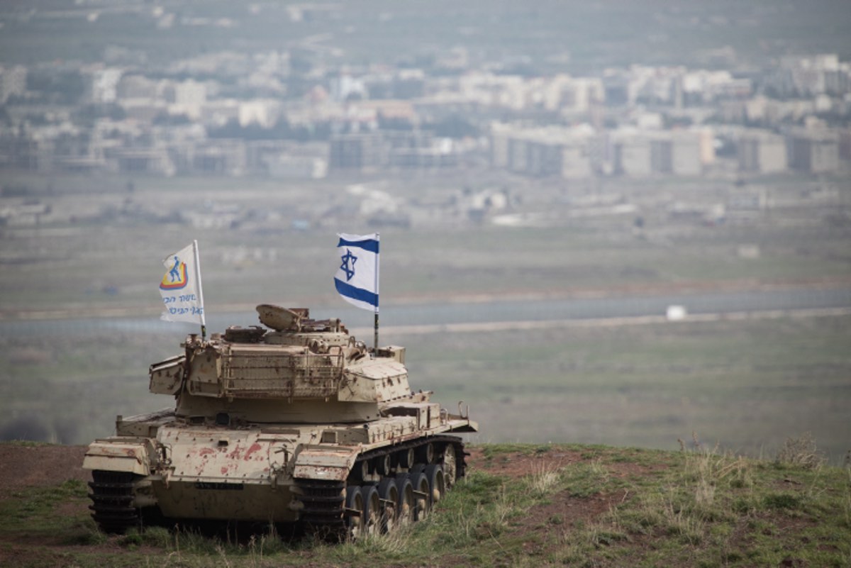 An old Israeli tank with a flag overlooking the Syrian town of Quneitra in the Golan Heights on Feb. 11, 2018. Photo by Hadas Parush/Flash90.