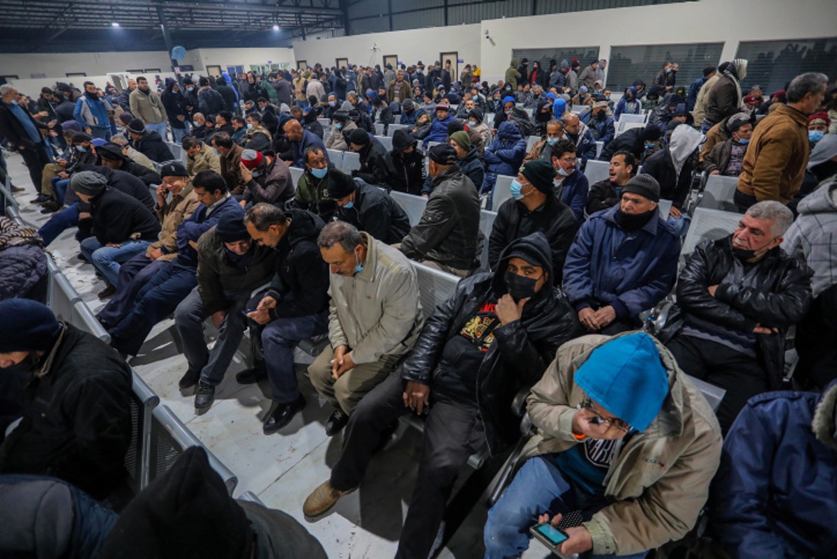 Palestinian workers wait at the Erez Crossing in Beit Hanun, in the northern Gaza Strip, as they wait to enter Israel for work, on March 13, 2022. Photo by Attia Muhammed/Flash90.