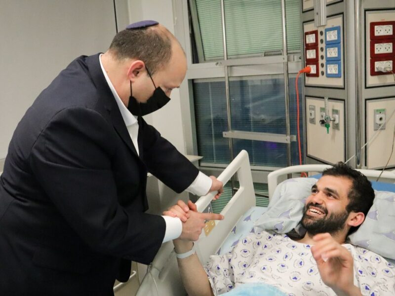 Israeli Prime Minister Naftali Bennett visits one of the civilians wounded in the deadly terrorist attack in Tel Aviv on April 7, 2022, at Tel Aviv's Sourasky Medical Center on April 9, 2022. Credit: Prime Minister's Office.