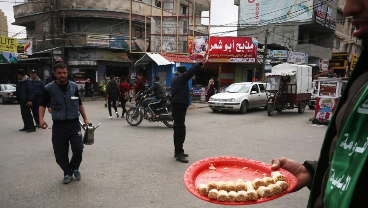 Palestinian supporters of Hamas pass out sweets in the street in Rafah in the Gaza Strip, following the terrorist attack where a Palestinian terrorist killed at least one man near Ariel, in the West Bank, on March 17, 2019. Photo by Abed Rahim Khatib/Flash90.