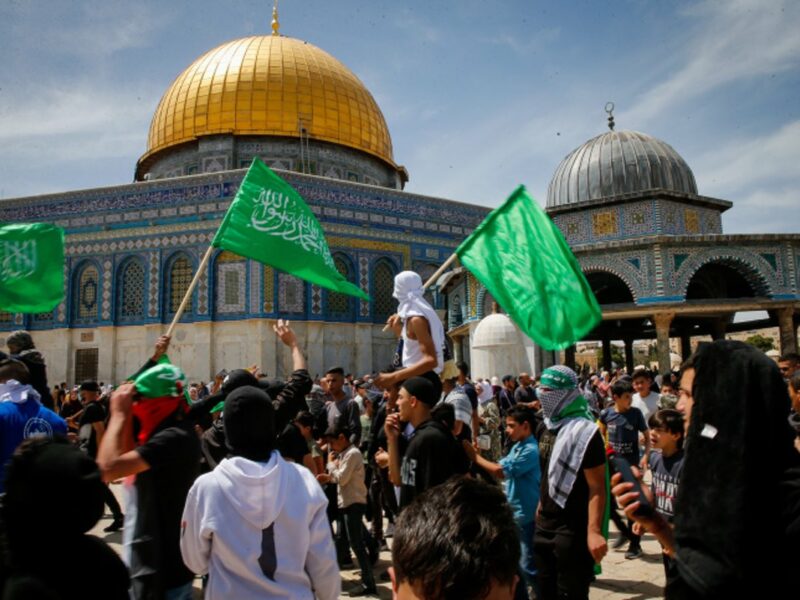 Protesters wave Hamas flags after Friday prayers of the holy month of Ramadan, at the Al Aqsa Mosque Compound in Jerusalem's Old City, Friday, April 22, 2022. Photo by Jamal Awad/Flash90.