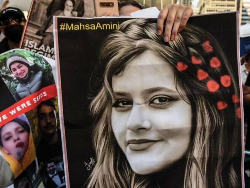 A protester holds up a picture of Mahsa Amini, a 22-year-old Iranian woman whose death in the custody of Iran's morality police has sparked widespread unrest Credit-Twitter.
