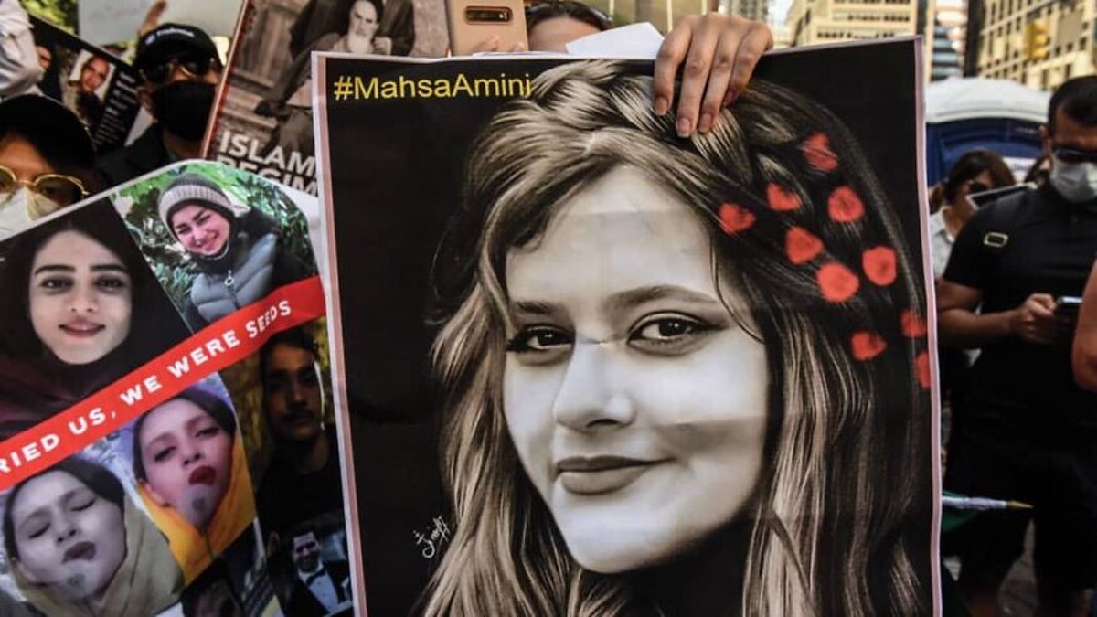 A protester holds up a picture of Mahsa Amini, a 22-year-old Iranian woman whose death in the custody of Iran's morality police has sparked widespread unrest Credit-Twitter.