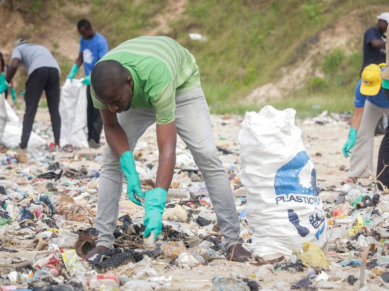 A man, collecting plastic waste at the beach during cleanup exercise in Ghana. Source: Fquasie, commons.
