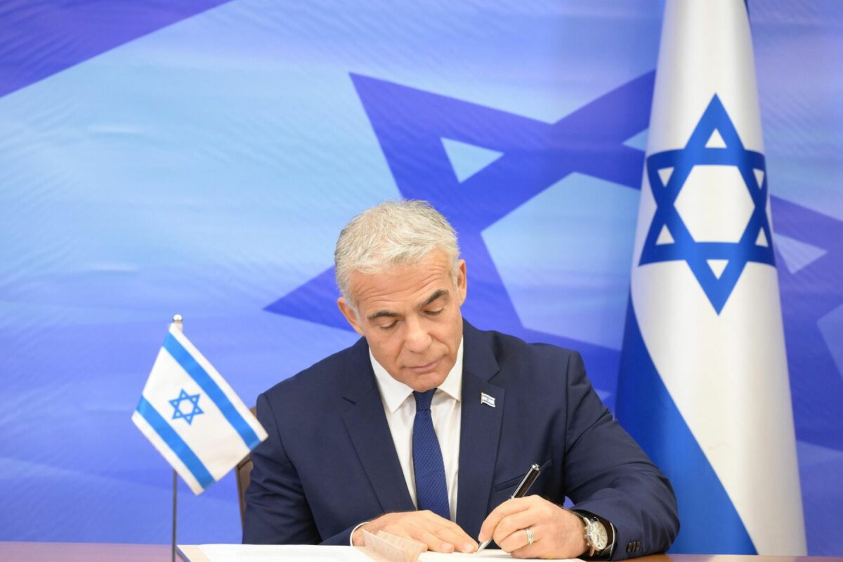 Israeli Prime Minister Yair Lapid signs the U.S.-mediated maritime border and natural gas deal with Lebanon, October 27, 2022. Credit: Amos Ben-Gershom/GPO.