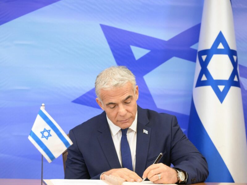 Israeli Prime Minister Yair Lapid signs the U.S.-mediated maritime border and natural gas deal with Lebanon, October 27, 2022. Credit: Amos Ben-Gershom/GPO.